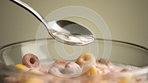 Concept of breakfast and food. Stock footage. Close up of eating colorful delicious and sweet corn rings and fruit