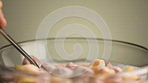 Concept of breakfast and food. Stock footage. Close up of eating colorful delicious and sweet corn rings and fruit
