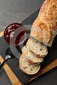 Concept of breakfast with toast with jam on wooden background