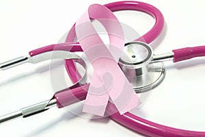 Concept of Breast Cancer. Pink ribbon near the pink-purple stethoscope doctor of breast screening, symbolizing the diagnosis, trea photo