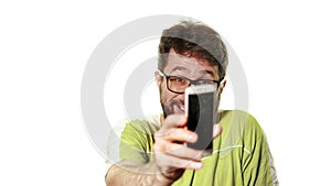 The concept of a broken gadget. Funny man with beard and glasses looking at his pink smartphone. He madly hysterically