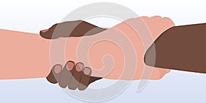 Concept of brotherhood and equality between men with two people of different colors, who are holding hands.