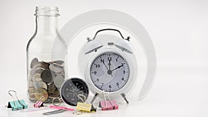 Concept Business finance and Shopping sale Coins in jar with White alarm clock Business objects isolated on white background