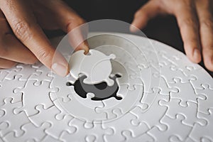Concept of business, Hand put the last piece of jigsaw puzzle to complete the mission