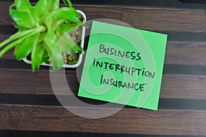 Concept of Business Interruption Insurance write on sticky notes  on Wooden Table