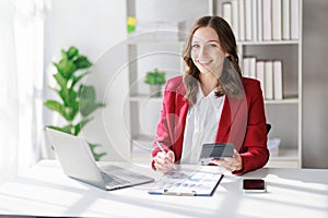 Concept of business office woman working,Businesswoman smile while working about her invesment plan with analyzing document and