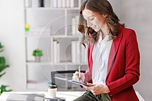 Concept of business office woman working,Businesswoman smile while working about her invesment plan with analyzing document and