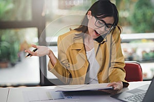 Concept of business office woman working,Businesswoman using smartphone talking to her client about invesment plan and checking