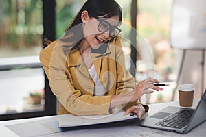 Concept of business office woman working,Businesswoman using smartphone talking to her client about invesment plan and checking