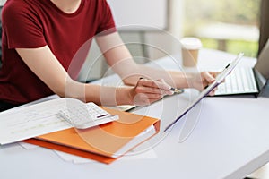 Concept of business office woman working,Closeup businesswoman checking her invesment plan with analyzing document and business