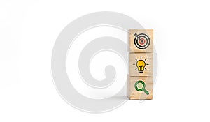 Concept of business strategy and action plan. Wooden cube block with icon target, light bulb and search on white background