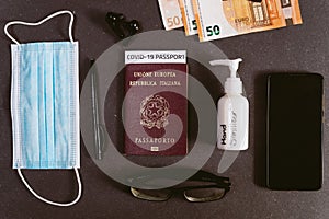 Concept of business travel with covid vaccination passport with covid19 immunity passport. hand sanitizer and mobile phone and