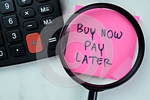Concept of Buy Now Pay Later write on sticky notes with stethoscope isolated on Wooden Table