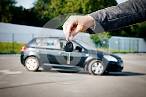 Concept of buying, selling and renting a car. A female hand hold