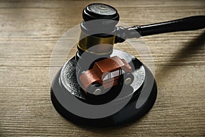 Concept of car auction,accident lawsuit or insurance. Gavel and a toy car