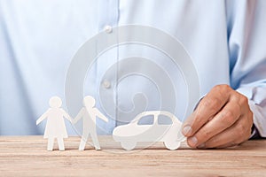The concept of car rental, credit or insurance. Man in shirt is holding car and family