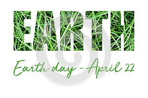 Concept card with Earth Day inscription on green grass.