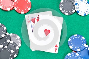 Concept of cards and poker chips on a green table