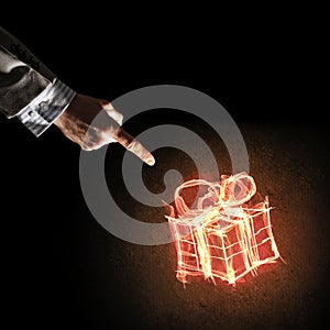 Concept of celebration with fire burning gift symbol and businessman palm