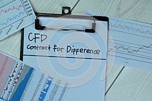 Concept of CFD - Contract For Difference write on paperwork isolated on Wooden Table