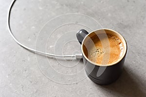 Concept for charging mobile device by sharing charge from caffinated drink