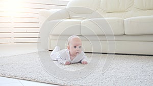 Concept of children and parenthood. Cute Happy Baby is Lying on Carpet