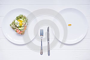 Concept of choice - healthy food or medical pills, top view on the white plate and wooden table. Choice between natural and synthe