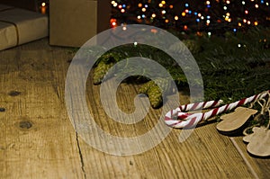 Concept of Christmas Eve, presents. Wrapped gift boxes, sweets, decorative mittens, fir tree on the rural surface