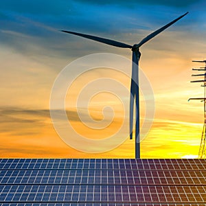 Concept clean energy. wind turbine and solar panel in sunset background.