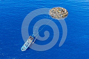 Concept cleaning ocean water from debris and plastic. Removing contaminants using ship and grid