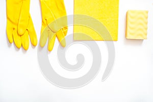 concept cleaning, on a yellow background pink gloves c soft dust brush, melamine sponge and spray for glasses