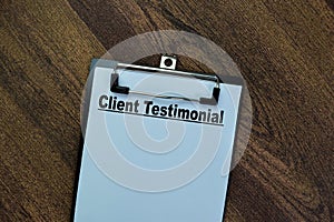 Concept of Client Testimonial write on paperwork isolated on Wooden Table