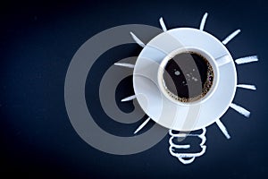 Concept coffee awakens brain on dark background top view