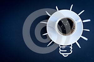 Concept coffee awakens brain on dark background top view photo