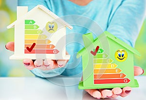 Concept comparison between normal house and low consumption house with energy efficiency rating