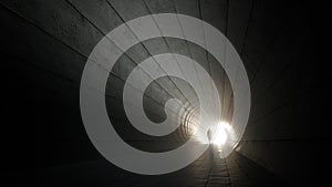 Concept or conceptual dark tunnel with a bright light at the end or exit as metaphor to success, faith, future or hope, a black