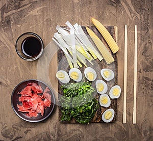 Concept cooking Chinese food, boiled quail eggs with seaweed Chuka, and corn wooden rustic background top view