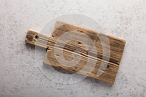 Concept cooking with empty cutting board on light concrete, close-up