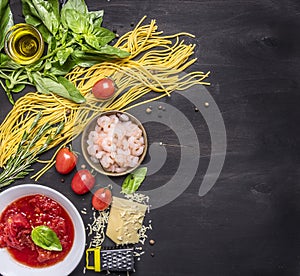 Concept cooking pasta with shrimp, tomato paste, cheese and herbs on wooden rustic background top view border ,place text