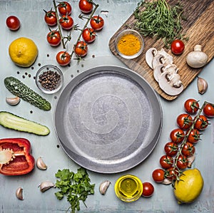 Concept cooking vegetarian food ingredients laid out around the pan with spices, mushrooms, butter wooden rustic background top