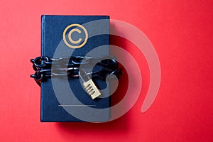 Concept for copyright, patent or intellectual property and idea protection. Book wrapped in a chain with a lock.