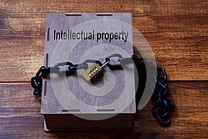 Concept for copyright, patent or intellectual property and idea protection.Box wrapped with chain on lock.