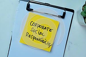 Concept of Corporate Social Responsibility write on sticky notes isolated on Wooden Table