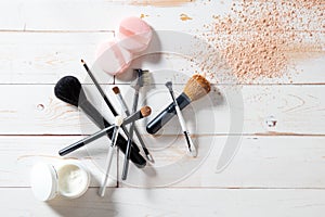 Concept of cosmetics and makeup with powder, skincare and brushes photo