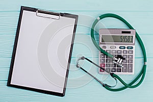 Concept cost of healthcare consist of stethoscope calculator.