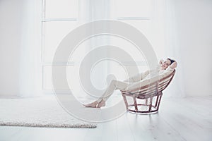 Concept of coziness, serenity and relaxation. Life is good! Pretty beautiful calm joyful woman in casual outfit is sitting on