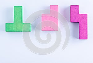 Concept of creative, logical thinking. Different colorful shapes wooden blocks on white background, flat lay, copy space.
