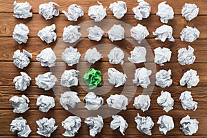 Concept of creativity and inspiration presented by many white paperballs and one color