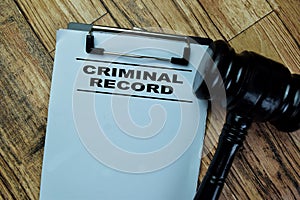 Concept of Criminal Record write on paperwork isolated on Wooden Table