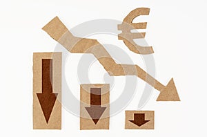 The concept of a crisis in the economy. On a white surface, a graph with down arrows and a euro symbol.